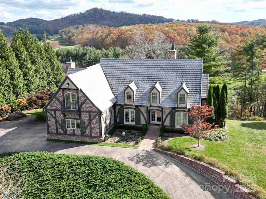 Luxury custom home in Jefferson Landing!! Experience refined mountain living in this high-end, custom-
built residence nestled within this exquisite gated golf course community. Designed with timeless details
throughout, this home showcases a gorgeous entry into the formal living room with high vaulted
ceilings, modern fireplace and exposed beams, elegant arched doorways throughout and lovely 6" white
oak flooring that create an open, airy sophistication. The heart of the home features hemlock custom
cabinetry in the kitchen paired with quartz countertops, GE Monogram appliances and walk-in laundry/pantry, hemlock paneling and built-in shelves in the library and an inviting sunroom blending natural beauty with
exceptional quality and functionality. The main level primary suite is a dream with a vaulted ceiling,
access to the rear deck and bath with walk-in shower, soaking tub and walk-in closet. The upper floor
offers 2 guest suites, each with a full bath and bonus space. The lower level expands the home's
versatility with additional guest space, unfinished space with endless possibilities and amazing storage.
Every room is thoughtfully designed to capture the spectacular mountain and river views. From its
architectural detailing to its warm, natural finishes, this home embodies comfort, and craftsmanship at
the highest level—while also offering privacy, beauty, and access to world-class golf and outdoor
recreation. Beyond the gate, enjoy activities including kayaking, floating or fishing along the scenic New
River, or exploring the beauty of the Blue Ridge Parkway, just a short drive away. When it’s time to
unwind, visit the bustling downtown of West Jefferson, filled with unique restaurants, vibrant art
galleries, and charming shops. Whether you’re seeking adventure or relaxation, this extraordinary home
places you in the center of the High Country lifestyle and will capture your heart!!