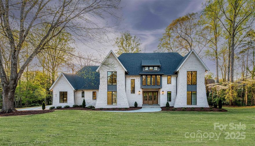 Stunning 2023 custom build on a private, wooded 1.21-acre lot in Jefferson Park min. from uptown. This ENERGY STAR home offers 5,376 sq ft with 5 beds, 5.5 baths, a vaulted bonus room, sitting room, huge gym, billiard room, office, and 3-car garage. The open-concept great room features exposed beams and flows into a chef’s kitchen with a 48" Wolf cooktop, 48" Sub-Zero fridge, 12’ island with 38" sink, and dual Bosch dishwashers. Large scullery with wine fridge, extensive prep space. Step through vanishing sliders to a 791 sf covered deck with retractable screens, fireplace, heaters, and fans. Enjoy the chip/putt green and fire pit patio. Oversized Pella windows, dual Trane HVAC systems, and 2 tankless water heaters complete this exceptional home. 5 min to Providence Day, Charlotte & Country Day School.