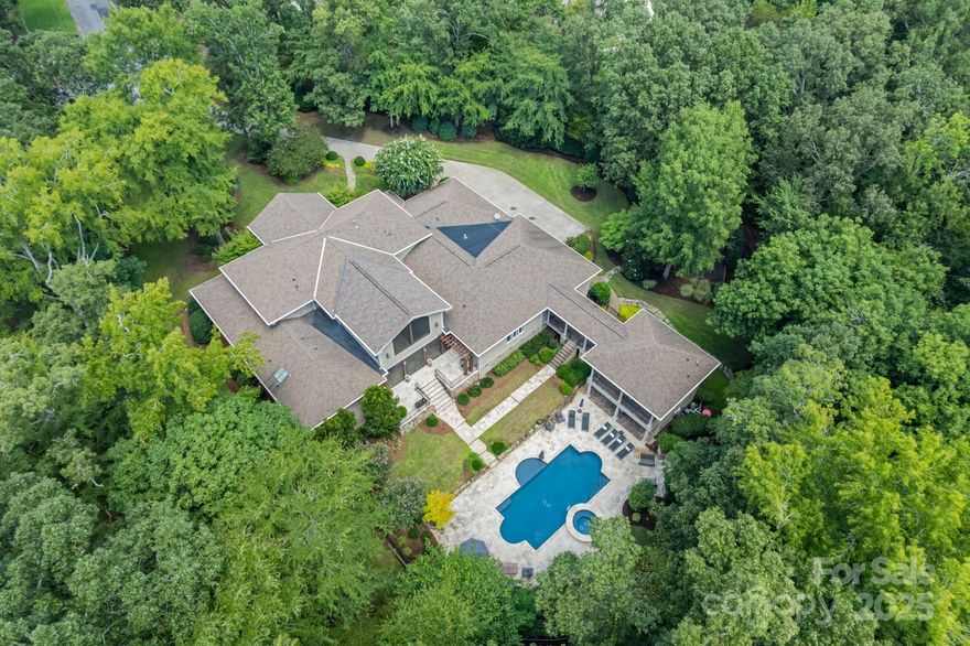 Luxury estate situated on 3 ACRES in prestigious gated community of Woodhall. High end custom kitchen, backyard oasis, furnished pool house, this home has it all. Mature trees on a private cul-de-sac lot located across the street from highly desirable Marvin Ridge Schools. Welcome into the home by a stunning two-story grand foyer with double staircase. The chef’s kitchen features top-of-the-line appliances, quartz countertops, and rich custom cabinetry. The main floor has a dedicated theatre room, recreation room with full wet bar, and a spacious primary suite complete with large walk-in closet. Entertainment inside and out with newly updated saltwater pool, outdoor grill area, 996-square-foot covered and screened lounge area with fireplace. Don't forget the outdoor batting cage with lights. Furnished pool house offers a full kitchen, living area, large bedroom, and two full bathrooms—ideal for guests or in-law suite. Meticulously landscaped grounds and maintained home.