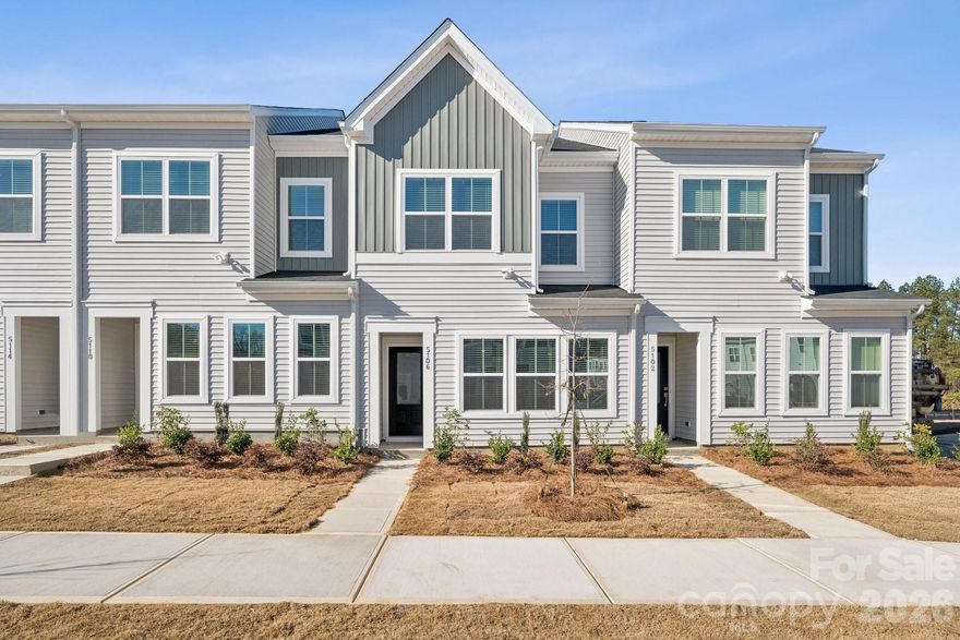Discover the charm of this boutique townhome community built by Mungo Homes, a leader in quality craftsmanship & luxury design. This beautiful east-facing two-story townhome features 3 bedrooms, 2.5 baths, & a rear-entry one-car garage, offering an open-concept layout w/ stylish upgrades finishes throughout. The main floor boasts luxury vinyl plank flooring, creating a seamless flow through the bright & airy living spaces. The chef’s kitchen is a standout, featuring a large sitting island w/ quartz countertop, white cabinetry, tile backsplash, pendant lighting, & SS electric appliances! Upstairs, the spacious primary suite impresses w/ a 10' boxed tray ceiling, generous walk-in closet, & a en-suite bath w/ a quartz-topped dual vanity & a tiled walk-in shower. Two additional bedrooms, a full bath, & a convenient laundry closet complete the second level. Located 10 minutes from Uptown Charlotte, the airport, & side-walk access to shopping at Target and Northlake Mall, Lakeview Village offers the perfect blend of style, comfort, & convenience. Ask about the included Move-in appliance package, Blinds, and Financing Promotions! 2025 Parade of Homes GOLD Winner!