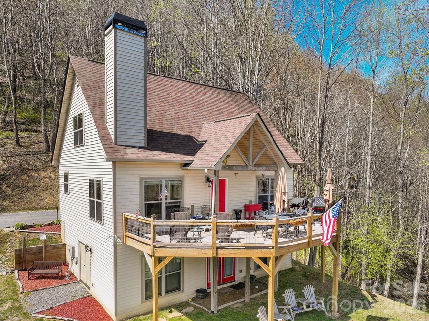 Discover the ultimate mountain sanctuary in this sleek, modern cabin nestled at the heart of 3.16 acres in the coveted Fines Creek community of Clyde, North Carolina. Offering unparalleled peace, privacy, and a complete escape from city life, this pristine three-bedroom, two-and-a-half-bath home welcomes you with breathtaking mountain views framed by nearly every window. Step inside to an open, light-filled living space where a signature Vermont Castings wood-burning stove anchors the cozy yet contemporary great room—perfect for savoring your favorite beverage while losing yourself in endless, captivating vistas that make every day feel like a private retreat. Country living at its finest awaits, featuring thoughtful modern finishes that blend seamlessly with the rugged beauty of the Blue Ridge Mountains. This versatile mountain home is designed for effortless expansion and future possibilities. The unfinished basement is already framed, pre-plumbed, and fully pre-wired for electrical, giving you the ideal canvas to create a fourth bedroom, spacious bonus room, or mother-in-law suite. The septic system is permitted and filed for a four-bedroom home, ensuring smooth permitting and unlimited potential to grow your living space or enhance rental income. Outdoor enthusiasts will cherish the location—just seven miles from Max Patch Bald, the iconic Appalachian Trail, and a network of recreational hiking paths that invite endless adventure right from your doorstep. Fully prepared and permitted for short-term rentals such as Airbnb, this cabin presents exceptional income potential alongside personal enjoyment as a weekend getaway or primary residence. Imagine waking to misty mountain mornings, exploring world-class trails by day, and returning to your private slice of paradise each evening. This is more than a home—it’s a lifestyle of serenity, freedom, and timeless beauty. Don’t let this rare opportunity in one of Western North Carolina’s most desirable mountain enclaves slip away. Schedule your private showing today and claim your forever escape in this modern cabin.