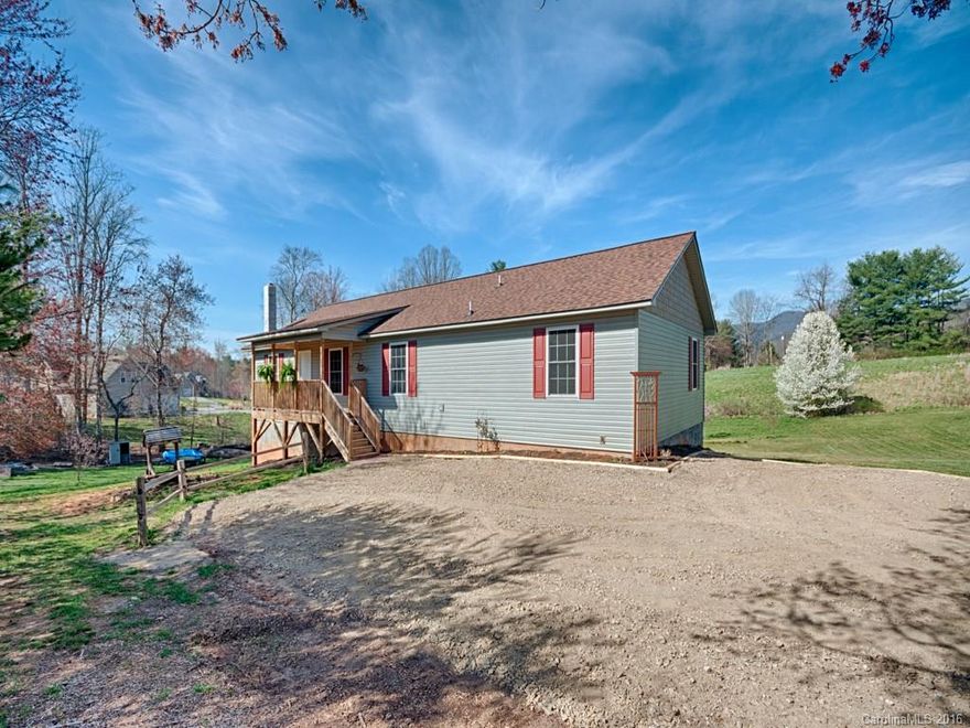 This setting is awaiting you!  Gorgeous home in desirable Candler with pasture like setting.  This open floor plan is inviting and perfect for main level living.  Lower level is gorgeous open space and an additional room with closets and large bathroom.  Beautiful decking perfect for entertaining.