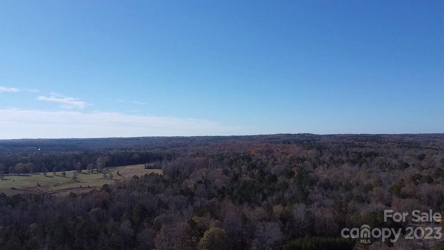 Discover nature at its finest with this approximately 33-acre parcel off George Dunn Road near Rock Hill, SC. Envision your dream home or the perfect small farm on this picturesque, wooded tract with endless possibilities. Escape to peace and quiet as you journey to this property offering the ideal canvas for your new home build or agricultural pursuits. The surroundings provide a unique opportunity to develop your vision using the natural beauty of the land. Property has approximately 435 feet of road frontage and property line borders Six Mile Creek. Property adjoins adjacent tract #1 which can be purchased separately creating a tract of approximately 64 acres. Property zoned RUD in York County. Part of Ralph Edwards Subdivision 1.