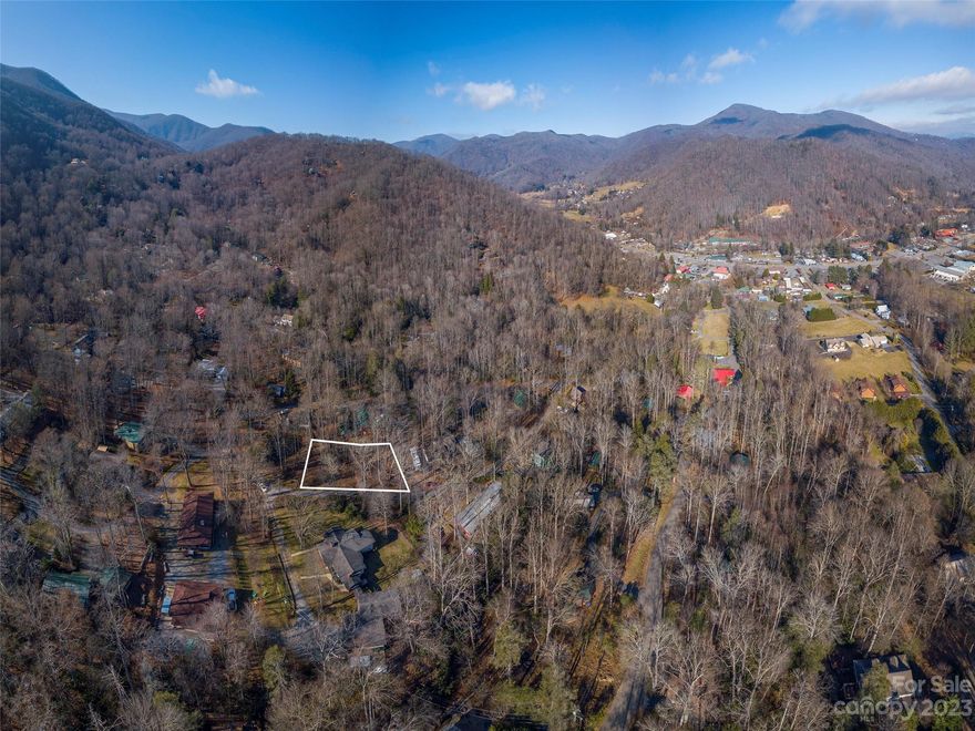 Private wooded, creek lot in Maggie Valley! This mostly flat corner lot has city water and sewer available and it borders a small branch. Excellent location with easy year-round paved access not far up the mountain and just minutes to Maggie Valley shops and attractions. Located at 3,000 ft elevation, offering cool breezes in the summertime. Perfect for your affordable mountain getaway, year-round home or short term rental in Maggie Valley! Lightly restricted square foot requirements under 800 square feet.