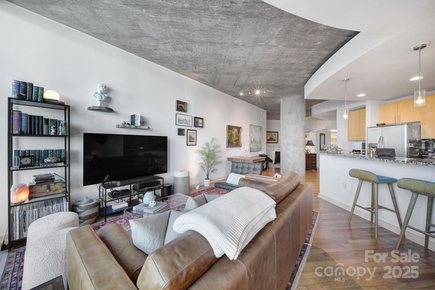 Welcome to the Avenue, one of Charlotte's premier high-rise communities in an amazing Uptown location. Boasting the building’s largest one bedroom, one bathroom floorplan, this highly functional and stylish condo epitomizes easy, sophisticated living. Hardwood floors flow throughout an open, modern kitchen and living concept facing floor to ceiling windows overlooking the city, with the added benefit of being on the quieter side of the building. Complementing the bedroom are a custom walk-in closet and full bathroom. Take advantage of the huge storage space within the in-unit laundry and utility room, not found in other floorplans. Recent upgrades include custom window shades and new water heater (2024). A gym with new equipment and yoga room, amazing year-round heated saltwater pool with brand new deck furniture, clubhouse and lounge area with cooking and hosting in mind, and a 24-hour concierge lobby service bring leveled-up amenities. Internet and water included with HOA. Come start your next chapter at the Avenue.