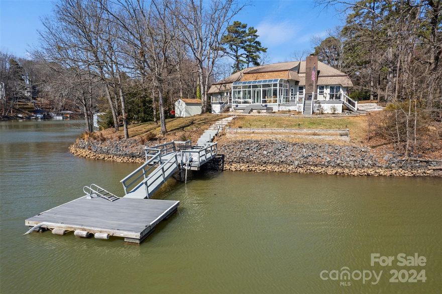 Don't miss this MOVE IN READY Classic Tega Cay Waterfront home! No HOA, this is a sprawling ranch on 3 lots, over 3/4 of an acre & flat to water. Enter the spacious foyer to enjoy the Lake Wylie view from here.  take in the panoramic view from all season sunroom. Eat-in kitchen, DR, den & great room. Rip Rap wall, Pier & dock. Oversized 2 car garage, circular driveway, tons of parking. This is a one-of-a-kind waterfront location.
Large multi-purpose parks, walking trails, waterfront parks, boat launch areas, ball fields, all-inclusive playground, golf, tennis, croquet, pickleball, pools, clubhouse, dog park, and so much more, just minutes to interstate 77, shopping, restaurants and recreation.
.  Lots TM# 6410101030 and 6410101032 are included in this sale, each .25 acres. 
Close to Charlotte in Beautiful York County, award winning Fort Mill Schools.