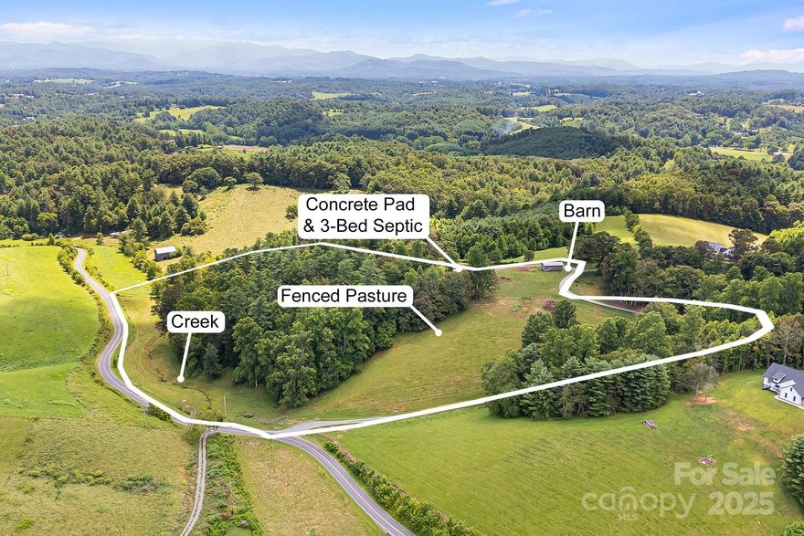 Located in Buncombe County with amenities just a few minutes away, this is a dream property if seeking land with views, fenced pasture, & a great building site with well & septic already installed. As a bonus, there is already a build-ready 36x50 concrete slab with stubbed out plumbing ready for your outbuilding, workshop, garage, or whatever else you may need it for. This property will make a great private estate, mini-farm, or great mountain vacation home. Seller to subdivide approximately 12.15 acres off of larger parcel prior to closing. There is already fenced pasture, partially wooded, with a babbling creek that runs parallel to the road and approximately 856' of road frontage. There is abundant wildlife on the property as well - turkey and deer are daily visitors. This is a must see property for those seeking privacy and tranquility in the country. Shown by appointment only. Video here: https://listings.wncrealestatephotography.com/videos/01982d55-6611-70ef-ac25-9a78822e5785