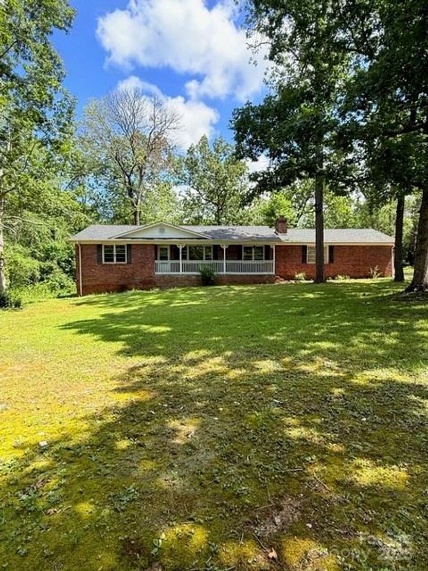 At no fault of seller, we are back on the market! Country living at its finest, this Move in ready 1,526 sq ft ranch-style home situated on 2 acres with beautiful mature trees. This well-maintained 3-bedroom, 2-bath home features a den off the kitchen with a beautiful wood-burning fireplace, perfect for a cozy second living space or home office. The main living room offers large front-facing windows providing great natural light and views of the tree-lined front yard. All bedrooms have plenty of space with the primary having two closets and its own en suite bathroom. Recent updates include fresh interior paint throughout and new tile flooring throughout the kitchen, laundry, hallway, and both bathrooms giving a modern look and easy for cleaning. Exterior features include a covered front porch and a back deck ideal for outdoor entertaining or relaxing. Plenty of room to spread out and enjoy the peace and privacy of a country setting. Seller offering $5,000 towards closing costs.