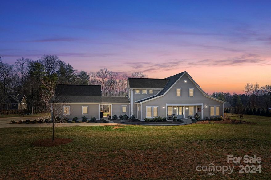 This stunning, custom built, Modern Farmhouse situated on 3.5 acres of Unrestricted Property in desirable Flat Rock, NC is a rare find! With it's soaring cathedral ceilings, gleaming, hand-scraped hickory floors, & 8 ft tall solid wood doors, this home is loaded with quality details. The open concept kitchen features a gas range and a huge granite island w/seating for 6, and the warm & inviting Great Room gets an abundance of natural light & has a stone gaslog fireplace surrounded by built-in shelving. The primary suite features a generous custom closet, dual vanities & walk-in showers, a large soaking tub, & separate HVAC system. The split floor plan offers 4 bedrooms & 3 full bathrooms on the main level, with an additional loft and half bath upstairs. The expansive finished basement is pre-wired for surround sound and has a bonus room & tons of extra storage. Outside you'll find a wrap-around veranda and a custom patio, a finished 3 car garage, plenty of parking, and a huge backyard!
