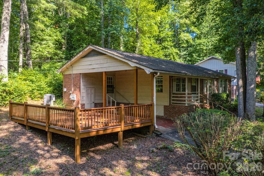 Daytrippers Dream Home! Excellent location - Motivated seller wants charming, spacious ranch sold now! This cozy home with newer heat pump (pictures show baseboard heat units on walls, but this home has a heat pump installed in 2022!)  is less than a mile walk to main street along a quiet, tree lined street with lovely cottages and two B&Bs. Original hardwood floors under carpets in every bedroom and in the hall per the seller. Huge deck right off the kitchen and carport for easy entertaining. Large shaded yard is perfect for gardening and there’s plenty of room for extra parking too! Short or long term rentals allowed!
Cute shops and restaurants line the main street. Saluda also has several public parks and picnic areas.
This home is in a terrific location for daytrips in North Carolina or South Carolina. Less than an hour to Greenville, SC. 20 minutes to Hendersonville and only 38 minutes to downtown Asheville. 
All appliances remain. American Home Shield Complete Warranty included too.