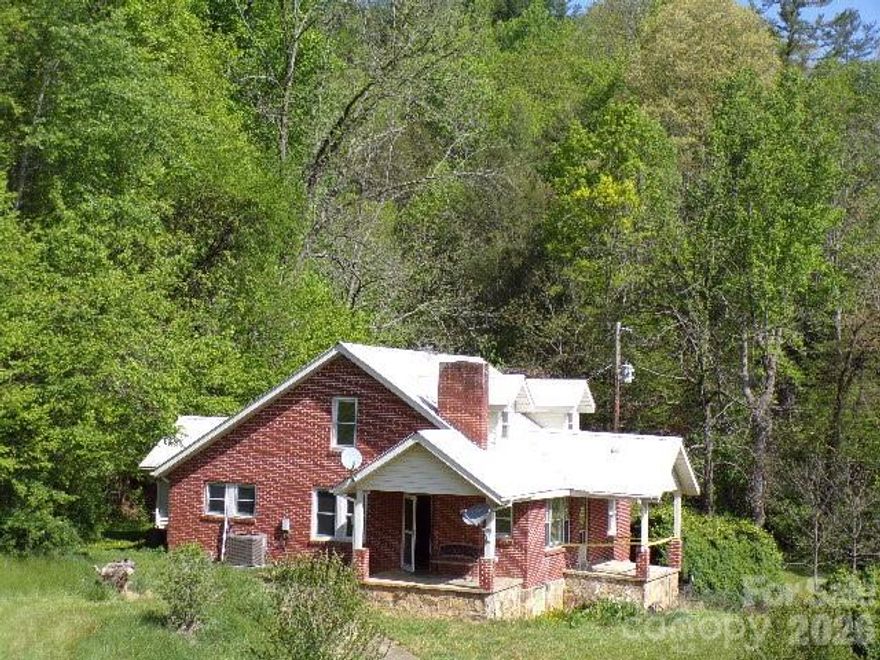 For buyers seeking a project, this property provides the chance to create something entirely new.  This traditional 1.5-story farmhouse sits on a 100-acre rural mountain property that includes pastureland, wooded hillside, creek frontage, and long-range mountain views.   The outbuildings include a multiple-car tandem garage/workshop, an equipment building, and a livestock barn.  This beautiful property is in Spring Creek Valley, surrounded by steep hills and a stream that flows into the French Broad River.  A short distance down the road is the Spring Creek Community Center that serves as a local gathering point.  The Hot Springs area is known for its Appalachian hiking and fishing. The home and outbuildings need restoration.  This is an estate transaction; the sellers have never occupied the home.  There is another dwelling at the property address 142 Kirk’s Dr that is uninhabitable and has not been occupied in decades.   Additionally, there are recorded right-of-ways to adjoining property owners.  The land across Hwy 209 and about one-third of the pasture fall inside the mapped floodway zone.  The home's general condition will not meet all financing requirements.   All inspections shall be for buyer information only; the sellers will not perform or pay for repairs, including appraisal-required repairs. The property is being sold strictly “As Is,” “Where Is,” and “With All Faults.” The seller is a trust representing the estate of the owners who passed away and therefore makes no warranties or representations, express or implied, including any warranties of merchantability or fitness.  No well permit was discovered.  Because the county’s recorded age conflicts with the home’s construction materials, the true age is considered unknown.  It's also unknown if there are buried fuel tanks on the property.  Property showings are available by appointment only. Please contact your Realtor to arrange a time.