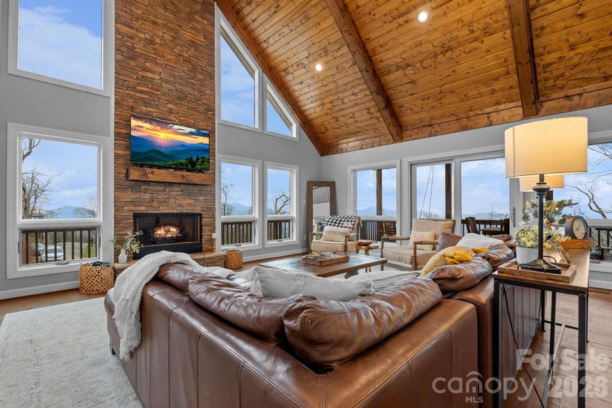 Perched at nearly 5,000 feet with sweeping long-range views, this fully furnished luxury retreat is the ultimate High Country escape — the kind of place where you'll count down the days until your next visit. And when you're not here? It can work for you, too, grossing over $100K annually for the past two years. Step inside and feel the mountain exhale. Soaring tongue-and-groove cathedral ceilings, a warm stone fireplace, and walls of expansive windows frame breathtaking southern views–flooding the space with natural light and the kind of scenery that never gets old. The open floor plan is where this home truly shines — living, dining, and kitchen flow seamlessly together, making it just as easy to host a lively dinner party as it is to sprawl out on the couch with a good book and a mountain view. The chef's kitchen keeps pace beautifully, featuring a farmhouse sink, center island, generous prep space, and a sunny breakfast nook. Slide open the doors to the partially covered wraparound deck, where a porch swing overlooks the views and a firepit table sets the scene for unforgettable evenings under the stars. The main-level primary suite is your personal sanctuary — complete with deck access, a spa-inspired bath with soaking tub, double vanities, and a huge walk-in closet. A second bedroom, full bath, and laundry room round out the main level. Upstairs, is flexible loft for a yoga space, reading nook, or home office, alongside two more bedrooms, and full bath. The lower level is pure fun: a second living room with fireplace, bar area, game space, bunk room, and direct access to a bubbling hot tub. An attached two-car garage and main-level carport make unloading skis, groceries, and luggage effortless. Best of all — built in 2021, this home is essentially worry-free, with modern systems and finishes that require minimal upkeep. Set in a small gated community just 3 miles from Beech Mountain Ski Resort, 4 miles from downtown Banner Elk's shops and restaurants, and just a few miles more to nearby Sugar Mountain Ski Resort, this is the mountain home you've been waiting for. Come for the views. Stay for the lifestyle. Let it earn when you're away.