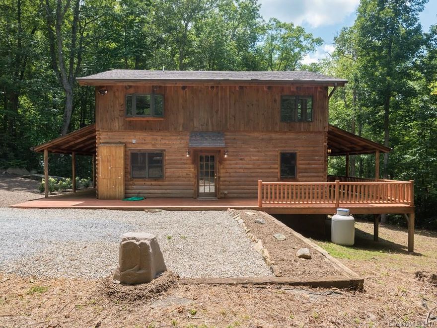 True mountain style living in Fairview! Come see this adorable log home surrounded by an acre of rhododendron and native plants. Great private location only 15 miles from downtown. SS appliances(brand new dishwasher) & granite countertops. The whole house has been freshly painted & brand new carpet upstairs. Enjoy the open floor plan & cozy stone fireplace. Relax on the wrap-around covered porch and listen to the creek as your worries melt away. Adjacent lot for sale (3273231)shares driveway
