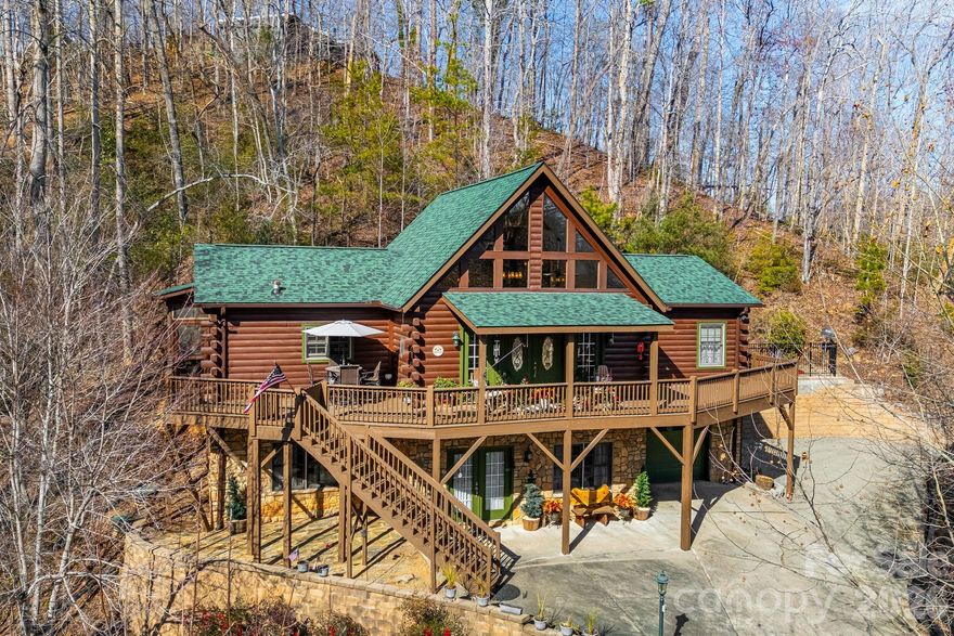 Come home to Riverbend, one of Lake Lure's most desirable communities!  Walk miles of nature trails with waterfalls and views or relax on the private lake's beach with covered picnic area.  The community has two separate private lakes and river access for your enjoyment.  Beautiful log home is set up for multi-generational living with two separate living spaces.  Upstairs, you'll find the spacious primary bedroom and guest bedroom.  The loft would make a great additional sleeping space, or use as an office or playroom.  The eat-in kitchen is a chef's delight and wonderful for entertaining numerous guests in the adjacent covered and screened-in porch just outside. Downstairs, you'll find an additional sleeping/living area with its own entrance from the garage or exterior.  Kitchenette includes microwave and refrigerator.  Full bathroom with shower makes it easy to rent out short or long term.  Short-term rentals are permitted inside this gated community.  Brand new flooring and roof/gutters in 2025; HVAC 2021. Pre-inspection report available to give you peace of mind.  Schedule your showing today for 158 Raven Blvd and embrace lake life living in the mountains.