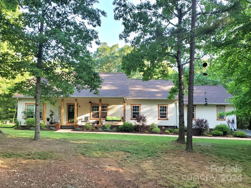 BACK ON THE MARKET AT NO FAULT OF THE SELLERS!!! IMMACULATE AND BEAUTIFULLY UPDATED HOME located in the EMERALD BAY, GATED COMMUNITY on HIGH ROCK LAKE. This home is nestled on 1.48 acres that offer privacy, and an  expansive NEW DECK, COVERED FRONT PORCH for bird watching, AND fire pit area for the outdoorsman to enjoy. This home features 3BR/2BA, with an open and split bedroom floor plan. The spacious primary suite includes 2 WALK IN CLOSETS, RENOVATED BATHROOM WITH DUAL VANITIES/WALK IN TILE SHOWER.  The kitchen boast  NEW GRANITE COUNTERTOPS/TILE BACKSPLASH/NEW HARDWARE/SINK/LIGHTING. NEW LVP FLOORING throughout, NEW CARPET IN BEDROOMS, NEWLY UPGRADED BATHROOMS, NEW PAINT, NEW HVAC (2023), NEW ROOF (2016), NEW LONG ASPHALT DRIVE LEADING TO HOME (2023), and many more updates! THIS HOME has been THOUGHTFULLY REFURBISHED AND LOVED. The Neighborhood includes a community boat ramp, secure boat storage, and day boat slips/dock for enjoyment.Walking Distance to Eagle Point Nature Reserve