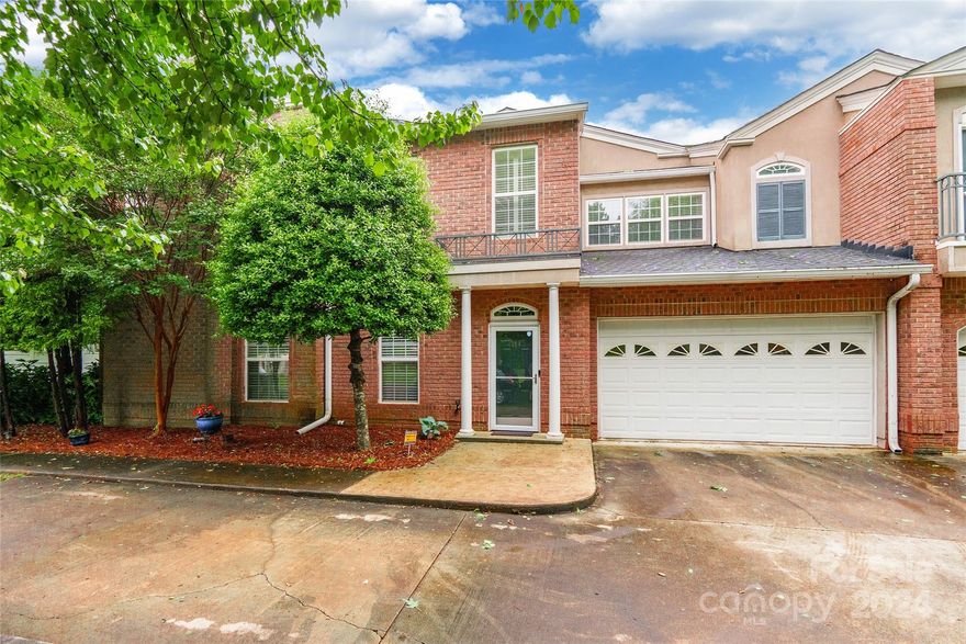 Discover urban luxury living in Dilworth South! This pristine 2-bed, 2-bath condo blends style, comfort, and convenience seamlessly. Enjoy a welcoming main level entry leading to a spacious 2-car garage. The kitchen dazzles with a pretty backsplash, ample cabinet space, and stainless steel appliances. Entertain effortlessly with a pass-through window to the dining area and a cozy breakfast nook. Step onto your private covered balcony through sliding doors for serene moments. Arched doorways and windows add an elegant touch. Relax in the spacious step-up living room with a gas log fireplace. The primary bedroom boasts an ensuite with a separate shower and garden tub, plus balcony access. With its prime location near shopping and dining hotspots, this very pretty condo offers a lifestyle of unparalleled convenience.