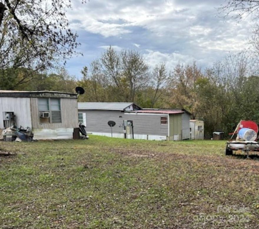 City water and sewer, selling Land Only, the Mobiles not being sold. Well kept mobile home village w and 7 pads and two old house sites where houses were removed all on municipal water and sewer. .87 acres , paved state road frontage . 
 
Owner will consider owner financing .