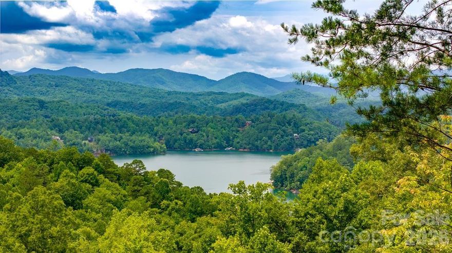 Welcome to your ideal mountain escape! This remarkable property offers sweeping, unobstructed views of Fontana Lake and the Great Smoky Mountains National Park. The homesite and level driveway are already excavated, plus a drilled well and approved 3-bedroom septic permit are in place—making it easy to start building your dream home right away. Conveniently located near the Fontana Lake Estates gate, you’ll enjoy paved, level roads for effortless, year-round access. This gated community is dedicated to preserving its pristine natural setting through thoughtful covenants, while offering amenities such as scenic walking trails, a private boat ramp, day-use docks, and charming gazebos for picnics or neighborly chats. Known for its friendly atmosphere, Fontana Lake Estates hosts regular gatherings and celebrations, creating a warm and welcoming environment for newcomers. Here, you can enjoy both privacy and connection—a rare combination. Don’t miss the chance to make this special community your new home!