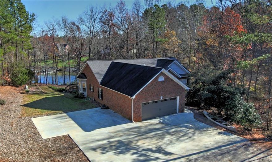 Waterfront in Clover school district, move-in ready! Custom brick ranch w/ full basement. Live on main level w/ 3BR, open kitchen/great room & office, new appliances, spacious screened porch.  Lower level - 2nd kitchen, huge rec room, 2nd office & room for guests. You'll love the huge screened porch, overlooking lake. Super comfortable & efficient in-floor radiant heat, multi-zone system, tankless water heater. Large 2.7 acre lot, mostly wooded for privacy, dock with boat lift on quiet cove.