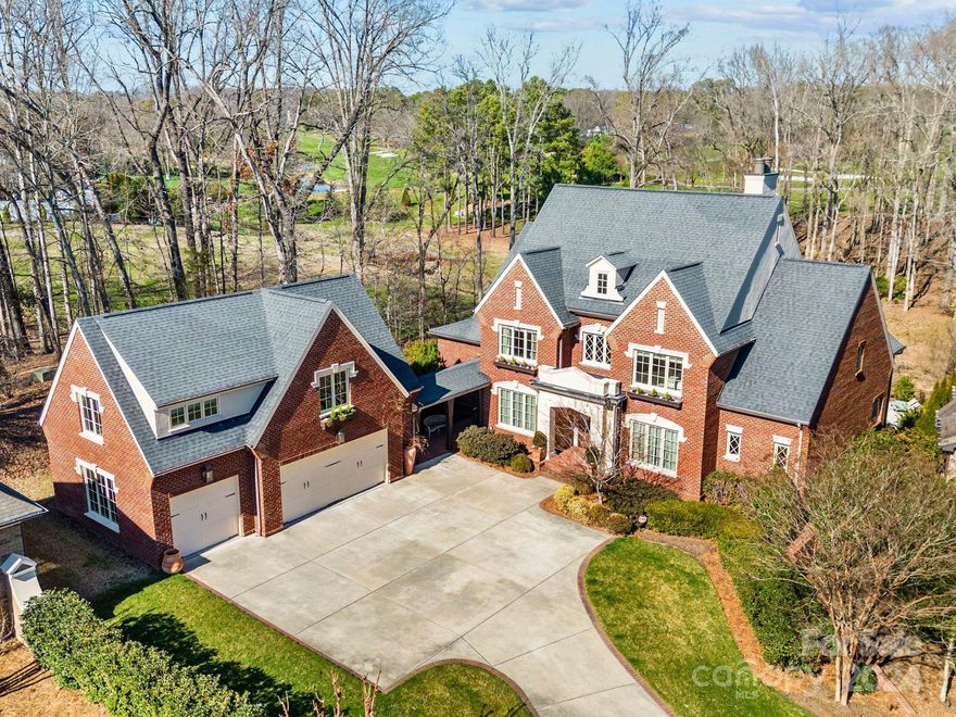 This beautiful brick home built by Kingswood Builders overlooks the 7th green of Quail Hollow Country Club. Open floor plan surrounded by windows from all sides of the house  provides views of the natural beauty/privacy of nature.  Exquisite gleaming dark hardwood floors, high ceilings, gorgeous moldings, arched doorways, walk-in closets. Chef's Kitchen with Sub-Zero and Wolf appliances. Primary Suite with sitting Room on main, primary bath with marble, spacious walk-in closet w/washer, dryer hook ups. Bedrooms have en-suite bath or connecting bath. Several rooms have access to the spacious terraces. 3 Laundry areas, 4 Fireplaces. Home theatre ,great room on lower level and bonus room on upper level . Gorgeous heated saltwater pool with Travertine stone surround recently updated, fire pit, patios/covered porch. Second Liv. Q above gar. 2 bedrooms, den, fb,& kitchen. This exquisite property is designed for entertaining!