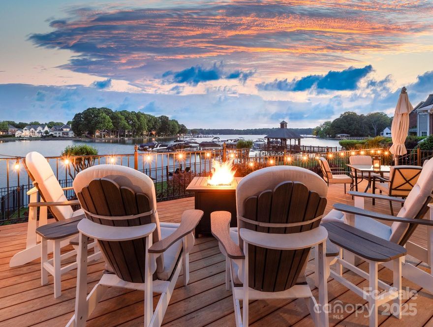 Situated in Cornelius' prestigious 100 Norman Place, this lakeside haven boasts 180-degree tranquil cove views, stunning sunsets, direct lake access and fenced yard. Enjoy a deeded boat slip just steps away, private swim dock & expansive outdoor living with screened-in patio, huge deck & fire pit. Inside, the soaring 2-story great room is anchored by a dramatic floor-to-ceiling stone fireplace. Chef's kitchen features stone counters & Thermador appliances. Formal DR has elegant wainscoting & built-ins. The main-level primary suite offers bay window lake views & deck access. Upstairs offers 2 bedrooms & a bonus room. This natural-light-filled home provides stunning lake views from almost every room. The crawlspace is encapsulated with a dehumidifier & new HVAC system added in 2022. Residents enjoy a pool, clubhouse, pickleball/tennis court, & HOA-included landscaping. Minutes from Birkdale, CLT & Uptown Charlotte, this home is the epitome of refined, yet convenient, lakefront living.