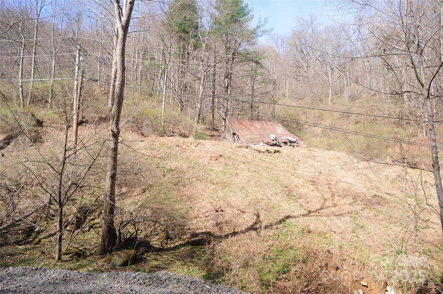 Beautiful 14.39-Acre creekfront parcel on Coxes Creek located in Burnsville.  This property is unrestricted in a private moutainous area of Ramsey Township in Burnsville.  This property offers mountain views, 5 springs on the property, old logging roads and would provide the opportunity for short-term rentals or Airbnb.  This property is located close to Mount Mitchell State Park which is the highest peak East of the Mississippi River.  Mount Mitchell State Park features an observation deck that provides stunning panoramic views of the Blue Ridge Mountains. Enjoy golfing at the nearby Mt. Mitchell Golf Course which has ranked in the Top 10 Public Golf Courses in North Carolina Magazine in 1998.  This golf course is situated in a valley at an elevation of 3000' below the peak of Mt. Mitchell and offers 18-hole par 72 course with lodge, clubhouse, restaurant, lounge, putting green and pro-shop.  Come build your home/private retreat close to area amenities and attractions.