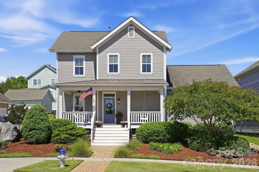 Experience the perfect blend of elegance and comfort in this METICULOUSLY MAINTAINED, quality-built Evans Coghill charming home in popular and vibrant Riverwalk! Nestled on a CORNER LOT right across the street from serene open green-space, this stunning craftsman home with an inviting southern-style front porch, offers an unparalleled lifestyle. From the moment you arrive, the timeless architecture and beautifully-manicured landscaping set a tone of sophisticated charm. Boasting 4 bedrooms and 2.5 bathrooms across 2684 square feet, every inch of this home has been thoughtfully designed for modern living. Soaring 9' ceilings and heavy crown moldings throughout home. The stunning Kitchen is a true chef’s delight featuring upgraded 42" white cabinets with glass, stainless steel appliances, gas range, granite countertops, an expansive central island, tiled backsplash, and a walk-in pantry. The heart of the home flows from the kitchen through the dining area into the living space - all ideally made for everyday moments and easy entertaining. Enjoy views to the FENCED BACKYARD from the generous-sized living room. Your private sanctuary awaits on the spacious MAIN-LEVEL PRIMARY SUITE with tray ceiling, dual vanities, a large walk-in shower, and walk-in closet. A beautiful, custom-made drop zone adds beauty and function as you enter the primary oasis. Flexible Living includes a dedicated home office on main level and a versatile second-level loft perfect for a media center or playroom. Three bedrooms and full bath complete the second-level. Loaded with RECENT UPGRADES including exterior & interior paint, refinished (light-colored stain) site-laid hardwood floors, hardwood finished staircase, newer carpet on second-level, irrigation in front and back of home, fenced back yard, drywall & epoxy floor in garage and plantation shutters throughout home. Step outside to your private retreat. The covered back porch is perfect for morning coffee or evening entertaining, overlooking the perfectly-manicured backyard. Additional paver patio space with exterior outlet wired for outdoor TV. The detached 2-car garage encloses the space for a true courtyard setting. Riverwalk has access to amazing amenities including a community pool with lazy river, clubhouse, playground, sidewalks, scenic walking trails, canoe & kayak launch points, BMX Supercross Track, velodrome, criterium course, local dining, wine bar, shops, and convenient canoe/kayak access. This golf cart-friendly neighborhood offers quick access to I-77 (via the new Palmetto Parkway), Rock Hill, Fort Mill, and Charlotte—making it perfect for commuters and those seeking an active lifestyle. Experience the best of Riverwalk living in this MOVE-IN ready charming home!