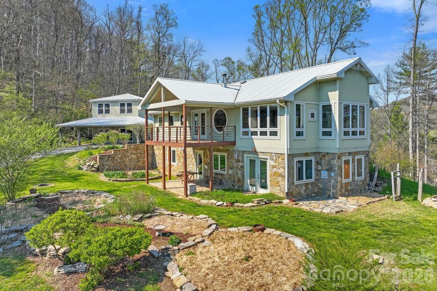 Stunning custom home and guest cottage on 31 MOL private acres just a short drive to Downtown Marshall off Little Pine Road.  Main house has open floor plan with many windows and long range mountain views.  Built in wood burning fireplace with tile surround and wood stove as well as a zoned HVAC system.  Custom stained glass windows throughout the home and long range mountain views from almost every room.  The adjacent guest cottage conveys with all the furnishings and has radiant floor heating.  The lower level guest cottage is stubbed for kitchen and bathroom but currently unfinished and makes a perfect studio or sunroom.