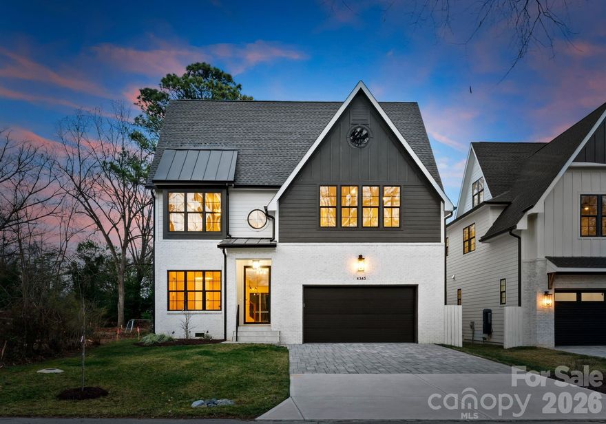 A striking blend of space, style, and sophistication, this exceptional new construction home in the heart of Cotswold showcases 6 bedrooms and 5 full baths across three expansive levels designed for elevated modern living. Positioned on a quiet street surrounded by other newly built residences, the home enjoys an exceptional location near Cotswold Village, SouthPark, Uptown, Providence Road, and Independence Boulevard, with convenient access to Charlotte’s top-rated public and private schools.

A covered entry and modern glass front door open to a light-filled interior defined by 10-foot ceilings on the main level, red oak hardwood flooring, elegant crown molding, and curated designer lighting throughout. The attractive modern color palette thoughtfully blends light tones and neutrals with rich darker tones, complemented by black hardware and gold accents on lighting and mirrors. The open-concept layout seamlessly connects the spacious kitchen, dining, and living areas, offering a grand, free-flowing environment ideal for both everyday living and elevated entertaining. The chef’s kitchen features an oversized island, floor-to-ceiling soft-close cabinetry, a generous walk-in pantry, and premium appliances. The adjacent dining area features a built-in buffet area with floating shelves and a beverage/wine fridge. 

The living room is anchored by a modern gas fireplace with a striking accent wall and opens through sliding doors to the fully fenced backyard. Outdoors, an expansive patio space is designed for gathering and relaxation, highlighted by a statement outdoor fireplace that beautifully extends the home’s generous living areas and enhances year-round entertaining.

A main-level bedroom with an ensuite bath offers flexibility for guests or a private home office. Upstairs, the primary suite overlooks the backyard and showcases an expansive spa-inspired bath with dual vanities, a soaking tub, and a stunning oversized walk-in shower with a built-in bench and multiple attachments, including a rain shower head. Designed to comfortably accommodate two, the oversized primary closet features extensive custom shelving, multiple clothing racks, and abundant dedicated storage space, creating a boutique-style dressing experience with exceptional organization and functionality.

Three additional guest bedrooms, a bonus room to be used as a home office, kid’s playroom, or storage area, and a conveniently located laundry room complete the second level. The third level features a spacious bonus area with a built-in bar, additional bedroom, and full bath, ideal for recreation, media, or extended stays. High-quality finishes, abundant living space, and a peaceful Cotswold setting make this home truly exceptional. The home is deeded in Craigmore Hills but is located in Cotswold.