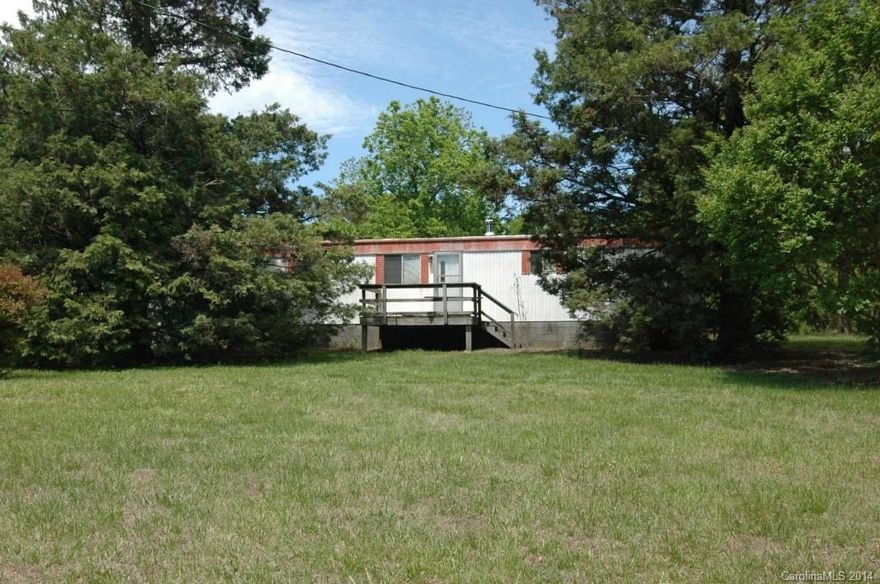 Over one acre land with investment potential or could be used for larger family.  Single wide mobile home with large deck and double carport.  Sellers installing tile floor through living area, and will be installing new heat pump, to be installed the morning of closing.  Second dwelling is a 1 bedroom, 1 bath house with a lot of potential.  If you want a property to come in a fix up, this could just fit perfectly for you!