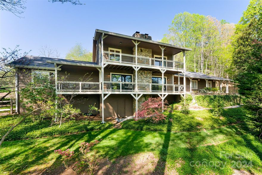 Discover a rare, one-of-a-kind estate nestled in highly desired Deerhaven. Spanning 4 acres of unparalleled beauty, this unique property boasts a meticulously crafted 3-bedroom, 3.5-bath, 3,554 square foot home awaiting your personal touches. Unwind in the charming main-level living spaces and primary suite or retreat to one of two ensuite guest bedrooms upstairs. Outside, embrace the serenity of flat pasture adorned with a quintessential red barn, perfect for equestrian pursuits or future expansion. Meander along a creek that gracefully winds through the property and enjoy the extensive gardens. Entertain effortlessly on multiple covered decks and patios, offering abundant outdoor living space. Enjoy all of the conveniences this outstanding south Asheville location allows without the confines of city taxes, HOA fees, or restrictive covenants, offering freedom and flexibility. This is an incredibly rare opportunity to own a truly unparalleled property where tranquility meets luxury.