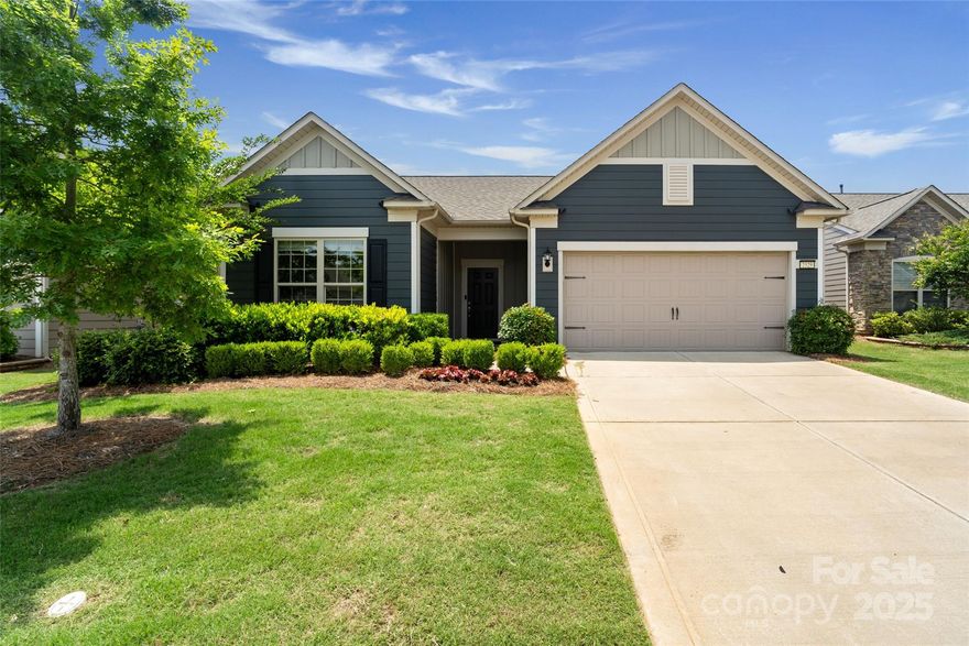 Step into this beautifully upgraded home nestled in the highly sought-after Carolina Orchards 55+ community. Designed for both comfort and elegance, this residence features luxury vinyl plank flooring throughout, a private office with French doors, and an impressive open-concept layout. At the heart of the home is a gourmet kitchen any chef will love, complete with a central island, gas cooktop, wall oven, and a dual microwave/convection oven. The kitchen flows seamlessly into the spacious family room, dining area, and sunroom—offering access to a serene rear patio, perfect for relaxing or entertaining. The luxurious primary suite includes bathroom with a tiled shower, dual-sink vanity, and a generous custom walk-in closet. Additional features include a convenient mudroom with drop zone and a 2-car garage. Whether you're enjoying the stylish upgrades, the vibrant lifestyle of the community, or the tranquil surroundings, this exceptional home is designed to elevate your next chapter.