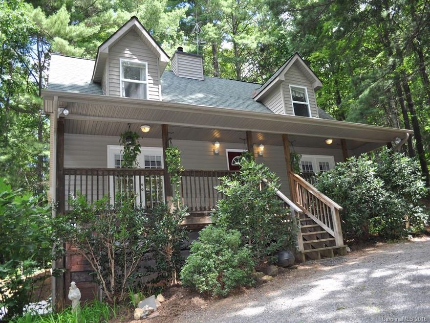 Enjoy a peaceful, private setting on 1.35 acres in an updated light, bright & open custom home, only minutes from all the conveniences of S. Asheville. Featuring a new Kitchen & Office addition, master on main, hardwoods, tile and slate. PLUS 2nd full kitchen & living area w/separate parking and entry. Work shop & storage. A steal @ $98 per square foot! Rocking chair, covered front porch and new rear deck facing undisturbed forest.