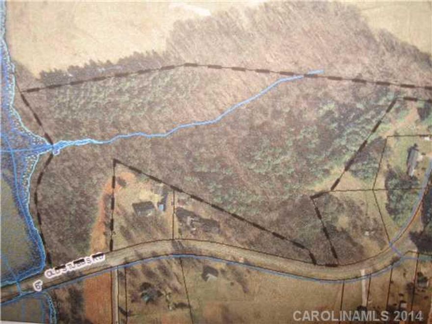 15.56 acres of wooded wonderland.  Water fronts up to west side of property.  No large boats can travel under bridge.  Great for hiking and camping.