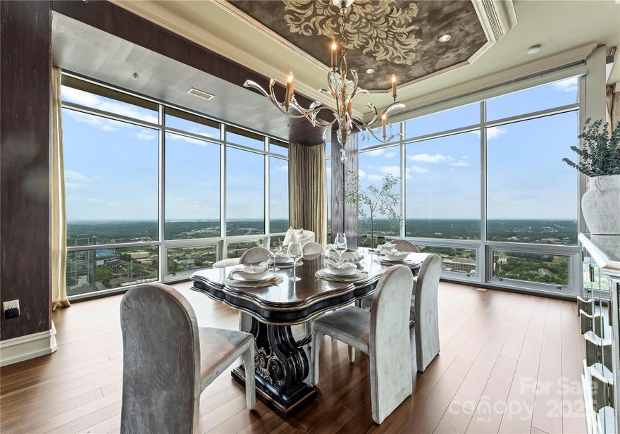 Rare opportunity at The VUE, Uptown Charlotte’s tallest and most iconic high-rise. This one-of-a-kind 43rd floor residence combines two premier units into an expansive, custom-designed home with floor-to-ceiling glass, soaring ceilings, built-in cabinetry, and Swarovski crystal wall accents. Enjoy an oversized terrace with panoramic views of Uptown, BOA Stadium, and Truist Field, plus a private terrace off the primary suite. Includes 4 secured, assigned parking spaces on the 3rd floor, 1 garage space on the 2nd floor, and 2 oversized storage units—an exceptional convenience. Resort-style amenities feature a Sky Lounge and cocktail bar, junior Olympic pool with cabanas, 35,000 sq. ft. sundeck, 24/7 concierge, state-of-the-art fitness center, spa with sauna/steam, basketball and tennis courts, VR sports simulator, pet park, guest suites, barista bar, and curated resident events. Experience the ultimate in luxury high-rise living at The VUE.