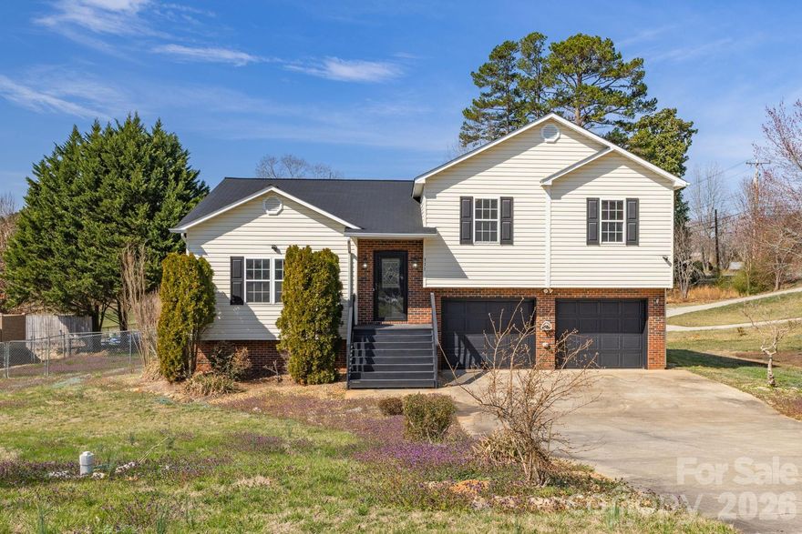 Welcome to 311 N Meadow Drive in Glen Alpine—a beautifully updated 3-bedroom, 2-bath home that offers the perfect blend of comfort, style, and flexible living space on a generously sized lot.

Step inside to a bright, welcoming main level where luxury vinyl plank flooring flows throughout—no carpet anywhere—creating a clean, modern feel that’s both stylish and easy to maintain. The inviting living room features a cozy gas fireplace, making it the perfect spot to relax on cool evenings or gather with family and friends. The kitchen and bathrooms showcase tasteful tile finishes that add warmth and character while maintaining a fresh, timeless look.

The lower level expands your living options with a spacious bonus area featuring painted concrete floors for a sleek, low-maintenance finish. This versatile space can easily serve as a family room, home office, gym, playroom, or media room—designed to adapt to your lifestyle.

Step outside and enjoy the outdoor living this property offers. A 14’ x 8’ rear deck is ideal for grilling, entertaining, or simply unwinding after a long day. The fenced backyard provides a great space for pets or play, while the expansive side yard offers additional room for gardening, recreation, or extra privacy. Convenient under-deck storage keeps outdoor equipment organized and out of sight.

Additional features include a double-car garage, durable low-maintenance vinyl siding, energy-efficient double-pane windows, and a gas furnace with central air to keep you comfortable in every season.

Located in the charming town of Glen Alpine, this home offers the appeal of small-town living with lower taxes and convenient town services, all while being just minutes from shopping, dining, and everyday amenities.

Offered at $350,000, 311 N Meadow Drive is a home that offers space, flexibility, and comfort—ready for you to move in and make it your own.