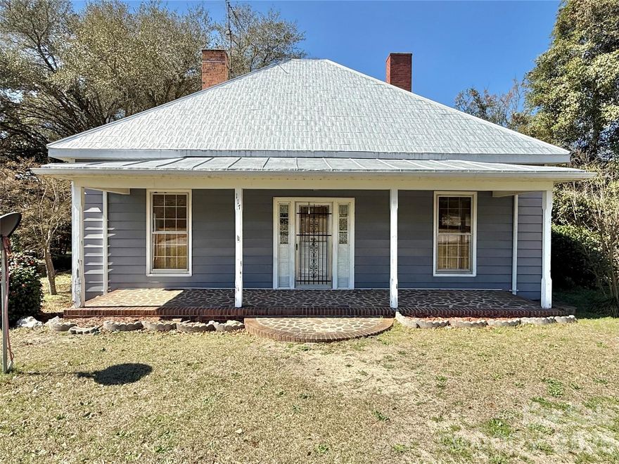 Charming two bed/two bath home in Morven! Sitting on 1.27 acres, this home provides ample space for outdoor living. This property includes a barn, chicken coop and a 16x24 outbuilding that has power, water and a large covered patio. A covered front porch spans the entire length of the home with plenty of room for rocking chairs or a porch swing. Beautiful, mature trees offer lots of shade in the back yard. Inside the home, you'll find tall ceilings, two bedrooms, a living room, den, sunroom/dining room, and two full baths. It also has a attic fan that can be used to help cool the home. This home has good bones and is ready for your own personal touch!