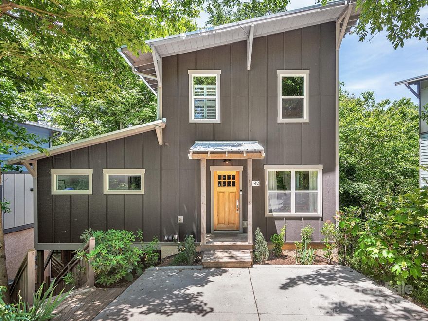 Come enjoy the treehouse feel of this home only a short walk to Carrier Park and all West Asheville has to offer. Main level with bright kitchen, dining room, large living room with built in office area, laundry room, half bath, screened porch, & deck. Upstairs is two bedrooms, a full bath with tub. The basement level has a separate entrance that is currently an active short term rental. This level includes bedroom with fireplace, bath with tile shower, walk-in closet, large screened porch, & hot tub. Floor plan drawing & home inspection provided.