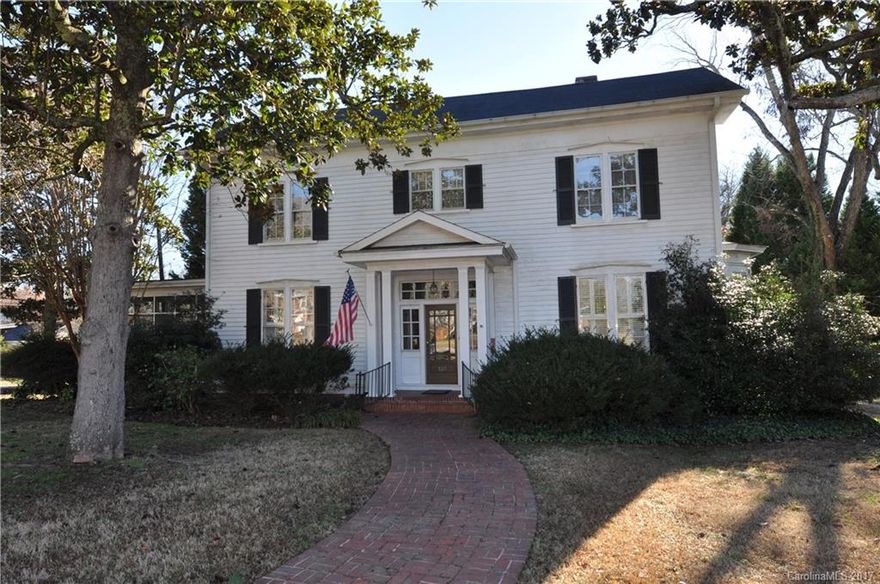 Graceful southern home built in 1890. 5BR/2BA. Master on main. Breathtaking crown molding is featured in the entrance foyer, formal living room and study. French doors open from study to a lovely screened-in porch. Bright kitchen perfect for entertaining. Large formal dining room. Gas fireplaces in LR & study. Gorgeous hardwood floors. Private patio leads to "secret garden", two-car garage. Walking distance to historic downtown. Easy commute to Charlotte and Columbia.