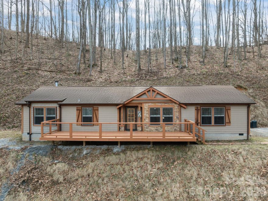 Built in 2019, this inviting 3-bedroom, 2-bath home offers approximately 1,809 sq ft of living space on 5.89 private acres at 193 Tipstill Cove in Waynesville. The property includes dedicated garden space and features a year-round spring running through the land — a rare and peaceful natural touch. Enjoy exceptional privacy while still being just approximately ½ mile from the interstate with no road noise. Ideally located, the home is approximately one mile from the entrance to the Blue Ridge Parkway and about 15 miles from Harrah's Cherokee Casino Resort. Just minutes from downtown shopping and dining, the home also provides convenient access to hiking, scenic mountain drives, skiing at nearby resorts, and mountain views. Don't wait — schedule your private tour today!