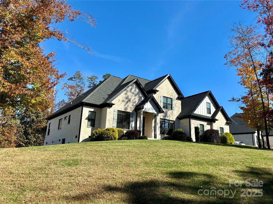 Immaculate and impressive! Brick home in Desirable Landing Moore's Ferry that is better than new. Open, airy, modern feel and neutral colors. Two story great room with gas fireplace open to gorgeous kitchen with induction cooktop, pot filler, island seating and breakfast/coffee bar with built-in lighted shelving. 3 pantries with custom wood shelving. His and hers double garages with epoxy floors. Elegant dining room with coffered ceilings. Screened porch and large patio for enjoying the large level lot (that is perfect for a pool!). Main level master suite with soaking tub plus walk-in shower. His and Hers walk-in closets with custom wood shelving. Spacious laundry room with sink, granite counters & storage. Sunny bedroom on main level for guests or office. Upstairs has 3BRs (one with en-suite bath), 2 baths and spacious bonus room. Large walk-in, floored attic with pull-down stairs to garage. Light hardwood floors throughout except for carpet in upstairs rooms. Welcome home to this gorgeous, move-in ready, quality home priced lower than building the same house as new construction! HOA dues are optional for beautification ($125/year). Large level lot with irrigation system ready for a pool!