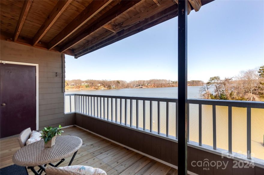 Get ready for year-round, unobstructed water views from this lakefront condo with coveted boat slip. End unit with no building to the right, affording more privacy than most. From the moment you step inside the foyer, you see all the way through to the water. The kitchen has granite countertops & stainless appliances and connects to the dining room with bar/cabinetry. The living room has a wood burning fireplace, and more built-ins and opens to the covered back deck with panoramic views of Lake Wylie. There are two bedrooms and two baths with updates, including the primary, which also faces the water. New heat/air just installed. Resort-like community with lovely pool and mature landscaping. Bring your boat, and dock it just down the hill in your slip.  Convenient location, near Berewick Town Center (grocery, restaurants and more) with easy access back to I-485 and the airport. Welcome Home!