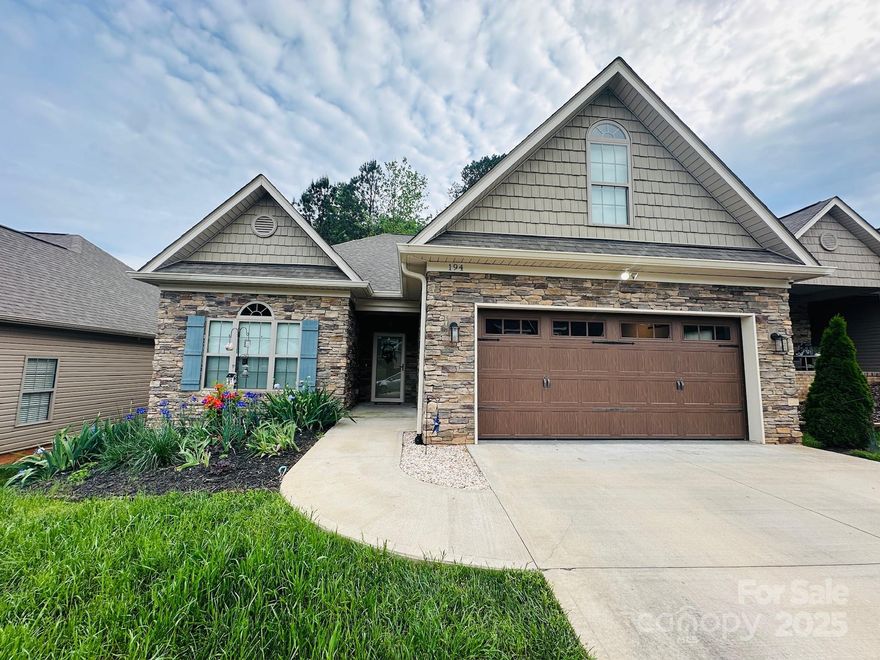 New Price. Come look.Exclusive custom built home in Villa's Italia community w/arch shingles, stone, brick veneer & shake siding. Built Dec 2021, this newer home is perfectly maintained & repainted w/new bdrm carpet. Spacious open concept living area boasts a natural gas fireplace w/ceramic tiled mantel, specialty sunburst windows, 9ft tray ceilings & dining area. Kitchen incl stainless steel appliances, touch faucet, granite countertops, lg island, tiled backsplash, drawer microwave, under counter lighting & walk-in-butler's pantry. A separate laundry/mudrm (includes W&D) is adjacent to double garage. The luxurious primary bdrm has a walk-in-closet, ensuite & 9ft trayed ceiling. The 2nd bedroom is bright w/custom windows & nice sized closet w/hall bath nearby. Home is designed with many extras: wide doors & halls, no steps, low thresholds, grab bars, mobility friendly floors, remote deck awning, floor outlets, windows in garage & alarm. Sliding glass doors open onto deck w/gas grill & woods behind.