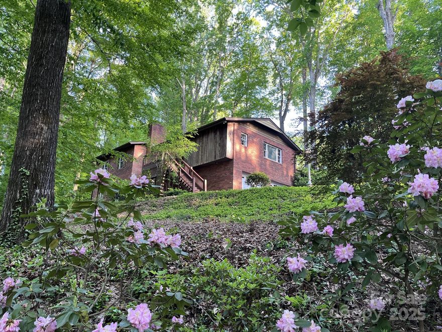 The perfect blend of privacy and convenience with this serene 3.16-acre estate nestled in the heart of Morganton. This 3-bedroom, 2.5-bathroom home with many recent updates is ideal for those seeking a tranquil lifestyle with easy access to downtown amenities.?The main living level boasts large open rooms with porcelain tile. The dining room opens to an ample-sized attached patio with a built-in brick grill and bench with plenty of space for seating, perfect for backyard entertaining. The kitchen features dolomite marble countertops, custom wood cabinets, and large workstation sink. Stainless steel appliances are under two years old and have an extended protection plan. Central to the kitchen is large island with a downdraft stove. Living room has brick fireplace and opens up to large deck. Lower level has two additional bedrooms with a Jack and Jill bathroom, a 2-car garage, and a separate climate-controlled workshop with hot and cold water. Built in dog wash in laundry room.