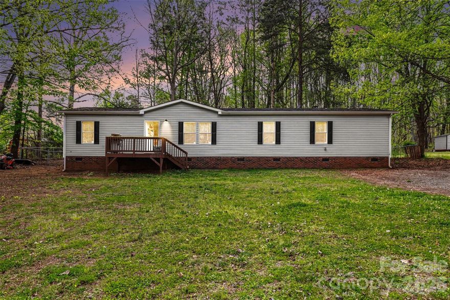 This move in ready 3-bedroom, 2-bath manufactured home delivers comfort, space, and a layout made for gathering. Enjoy an open living area anchored by a cozy fireplace plus a large kitchen with an island. Outback you'll also enjoy a deck for entertaining that offers privacy, room to relax and space to breathe. Your next chapter starts here.