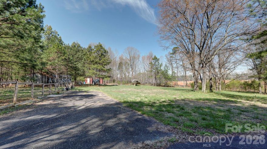 Large, flat, partially wooded lot with NO HOA!  Tucked away on over 2 acres in the heart of Mooresville, this property offers the perfect blend of privacy and convenience. This spacious lot provides ample room to build your dream home, create a private retreat, or invest in a growing area. Well and septic are already in place, helping streamline the building process and add immediate value. The property also includes two outbuildings, offering additional storage, workshop space, or potential for future use. With easy access to shopping, dining, and Lake Norman amenities, this rare acreage opportunity combines a peaceful setting with a highly desirable location.