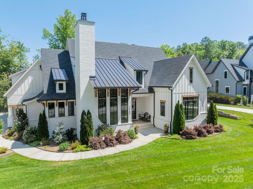 Experience elevated luxury and intelligent function in this custom-designed Modern Farmhouse surrounded by 37 acres of serene nature in Narrow Passage with easy access to River Run amenities, the greenway, and idyllic Davidson. This entertainer's haven features a Thermador chef's kitchen with marble waterfall island, two dishwashers, sliding drawer cabinets,  hidden pantry, and walk-in wine cellar. Living room expands via disappearing glass doors to a screen porch and expansive outdoor living area with outdoor kitchen, cultivated gardens, and fireplace all backing up to tranquil farmland. Elegant main floor master suite and guest suite are complemented by 3 large en-suite bedrooms upstairs.  Intelligent home automation via Control4 system.  Main floor office with high ceilings and dramatic fireplace. High end finishes include lighting, floors and window treatments. This is a rare opportunity to own a home that masterfully blends architectural elegance, technology, and natural serenity.