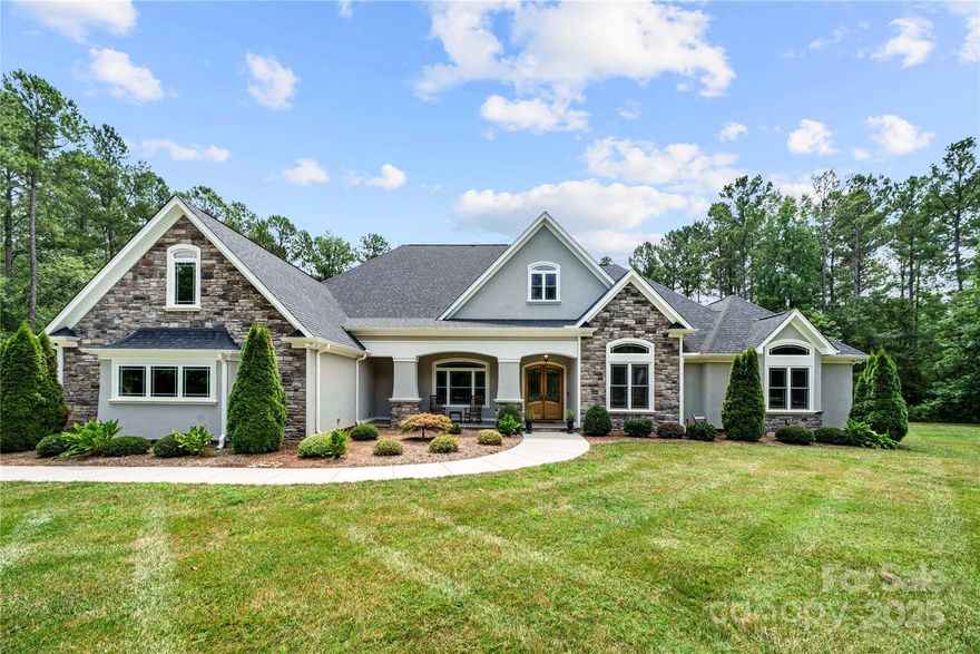 Experience luxury living in Henry's Glen with this custom designed home set on 2+ acres of tranquil, wooded landscape. Crafted with soaring 12–14’ coffered ceilings, custom decorative beams, and rich marble, porcelain, and hardwood flooring, this home is both elegant and inviting. The chef’s kitchen features an oversized island, gas cooktop, double oven and exquisite cabinetry, flowing into bright living spaces filled w/ natural light from expansive windows. Butler's area features built in kegerator and walk-in pantry. Spacious laundry room w/ tons of cabinets and counter space. The luxurious primary bath boasts dual vanities, a large jetted soaking tub, separate tiled shower, and 3 walk-in closets. Each of the 4 bedrooms includes a private bath, with the 4th bedroom doubling as an   spacious bonus room. Backyard has a resort-style pool, sprawling patio, and enclosed entertainment space with fireplace. 3car garage. Mins to CLT airport, shopping, dining and award winning Clover schools.