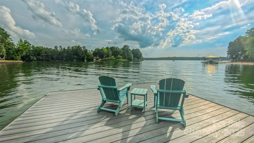Lake living at its finest! This beautifully renovated home sits on a quiet cove with main channel & sunset views.  The open floor plan with hardwood floors unites the dining, living rooms & kitchen. The deck spans the full length of the back of the house with fantastic water views. Crossing through the glorious sunroom, you enter the primary suite. The updated primary bath has a glass-enclosed walk-in shower, soaking tub & dual vanities. The renovated kitchen w/ quartz countertops, oversized kitchen island with ample cabinetry, electric range w/ herringbone tile backsplash & stainless exhaust hood. The private study sits just off the breakfast area. The Bonus room is a perfect recreation or flex space. The finished walk-out basement presents a family room with a fireplace, two additional bedrooms & shared bath. The outdoor lake living space is unmatchable w/covered patios, stationary, floating docks, and picturesque lake views. The garage has epoxy floors, & a large detached work shed.
