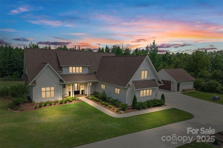 PRICED BELOW APPRAISED VALUE! Tucked away on 8.53 wooded acres, you’ll find this custom luxury estate. This home features high-end finishes & incredible design. The gourmet kitchen is a showstopper w/a large island, quartz counters, custom cabinets, breakfast bar, butler’s pantry, walk-in pantry, commercial-size refrigerator & an 8-burner gas range w/dual ovens. The primary suite on the main offers a retreat w/dual sinks, vanity, walk-in shower, spacious closet & direct access to the laundry room. You'll also find an office on the main level, while upstairs includes a large loft, bonus room & a 2nd laundry room. Outside shines with professionally landscaped grounds, inviting front & rear porches & a fenced backyard. Enjoy trails throughout the wooded perimeter, a wildflower garden & even a chicken coop with 11 egg-laying hens. With a 3-car attached garage & a 2-car detached garage, this private estate is as functional as it is beautiful—an exceptional opportunity to live luxuriously in a peaceful, natural setting.